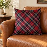 Față de pernă decorativă cu carouri roșii tartan pe canapea